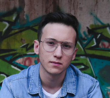 Young man in glasses near graffiti