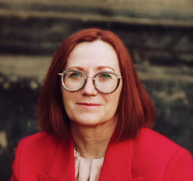 Woman with red hair and glasses